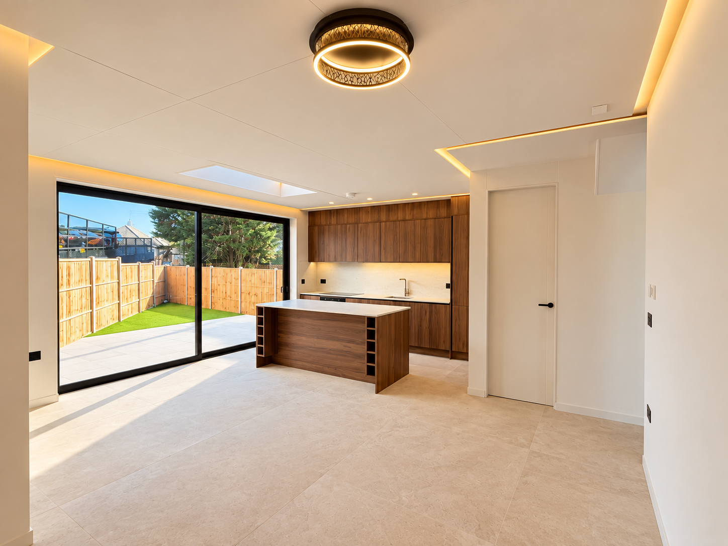 Open-plan walnut kitchen opening onto the garden in Barnet