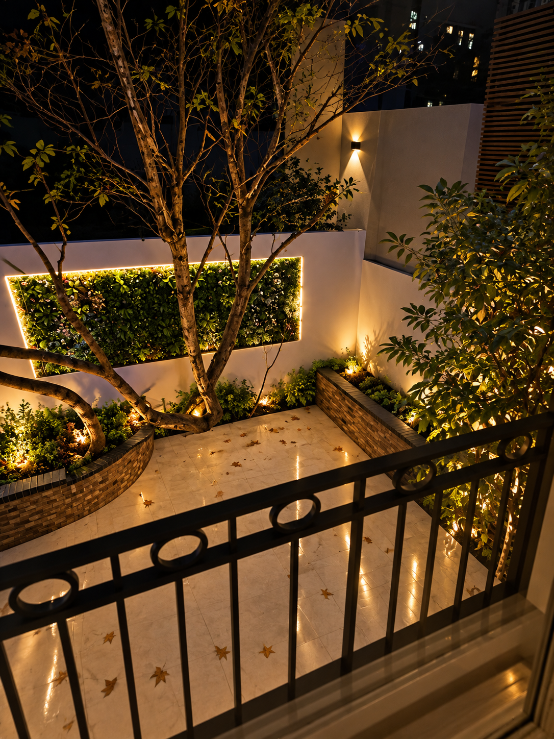 Courtyard garden at night with illuminated living wall