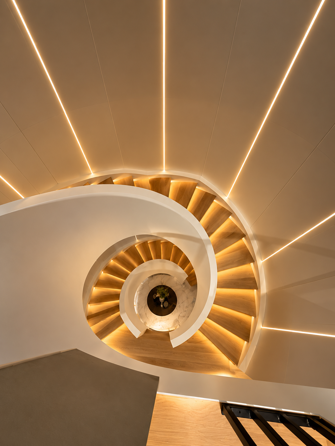 Top-down view of the spiral staircase with LED ceiling lines