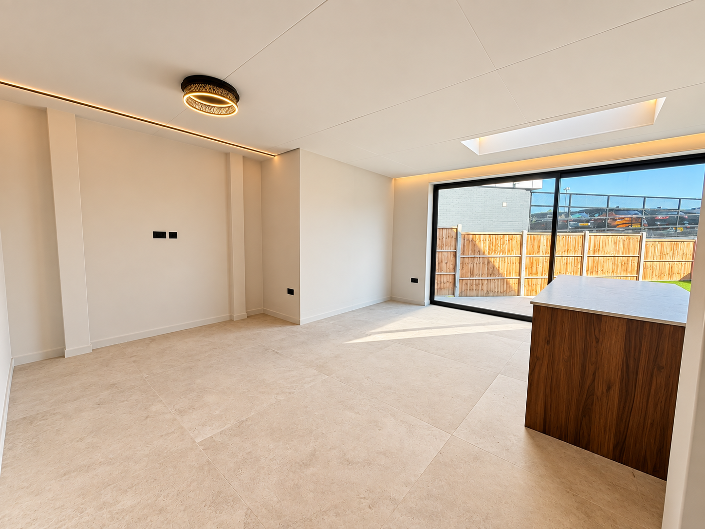 Bright living space with stone floor, rooflight and sliding doors to the garden